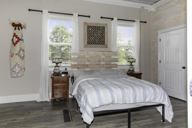 bedroom with crown molding and dark hardwood / wood-style flooring