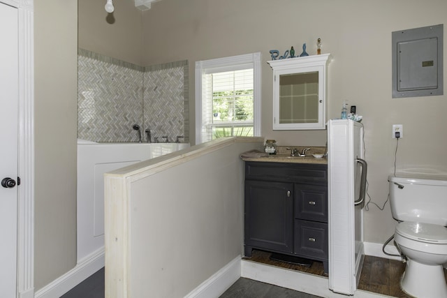 bathroom with hardwood / wood-style floors, vanity, toilet, and electric panel