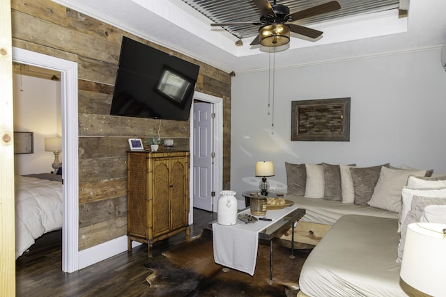 living room with ceiling fan, ornamental molding, and wooden walls