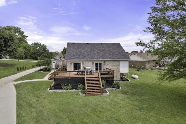 rear view of property featuring a lawn and a deck