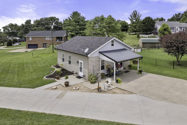 view of front of property with a front yard, a patio, and a garage