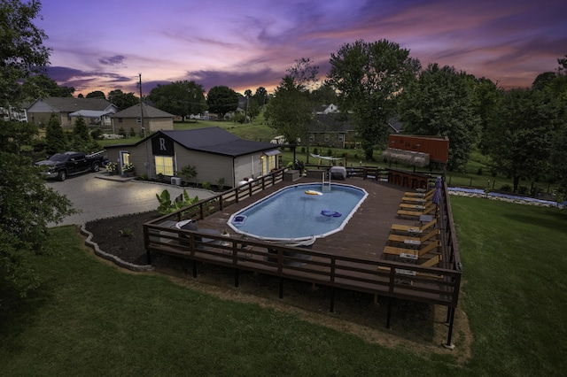 pool at dusk with a yard