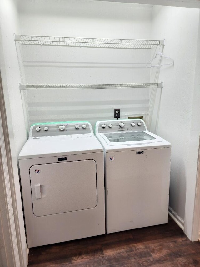 laundry room featuring dark hardwood / wood-style floors and washer and clothes dryer