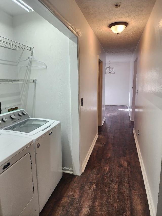 washroom with washer and clothes dryer, dark hardwood / wood-style floors, and a textured ceiling