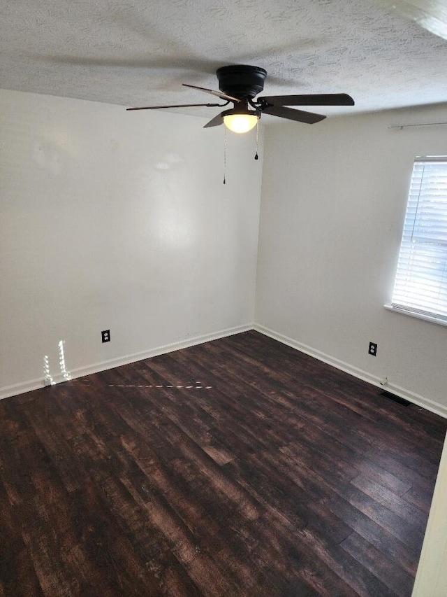 unfurnished room with ceiling fan, dark hardwood / wood-style flooring, and a textured ceiling