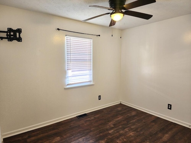 empty room featuring ceiling fan and dark hardwood / wood-style flooring