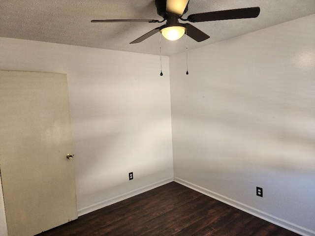 spare room featuring a textured ceiling, ceiling fan, and dark wood-type flooring