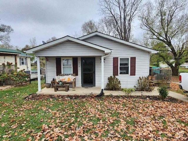 bungalow-style house featuring a porch and a front lawn