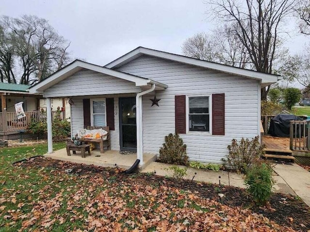 bungalow-style house with a wooden deck and a porch