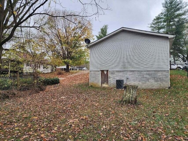 view of side of home featuring central AC unit