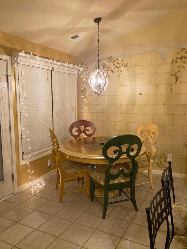 unfurnished dining area featuring lofted ceiling and light tile patterned floors