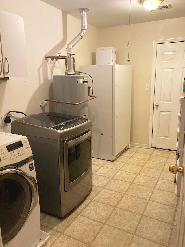 laundry room featuring cabinets and washer / clothes dryer