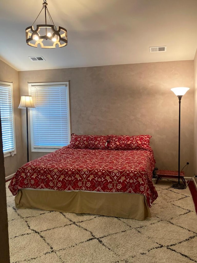 bedroom with a chandelier, carpet floors, and lofted ceiling