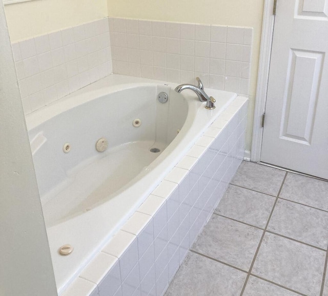 bathroom featuring tile patterned flooring and tiled bath