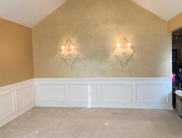 unfurnished dining area featuring light colored carpet, lofted ceiling, and a notable chandelier