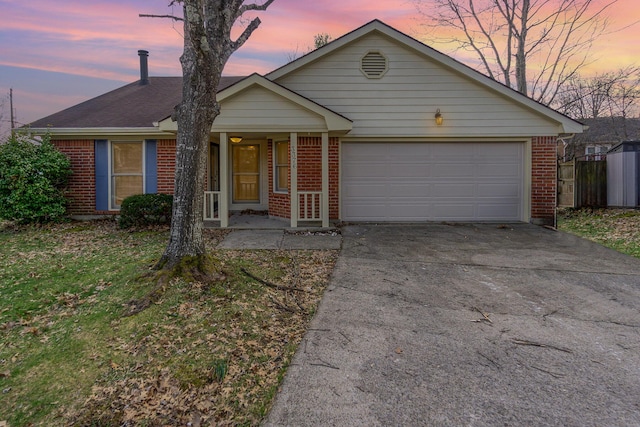 ranch-style house with brick siding, concrete driveway, covered porch, fence, and a garage