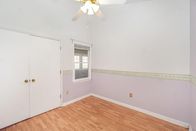 unfurnished bedroom with light wood-style floors, ceiling fan, baseboards, and a closet