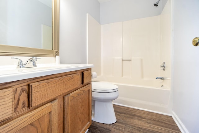 full bath featuring shower / tub combination, toilet, wood finished floors, vanity, and baseboards