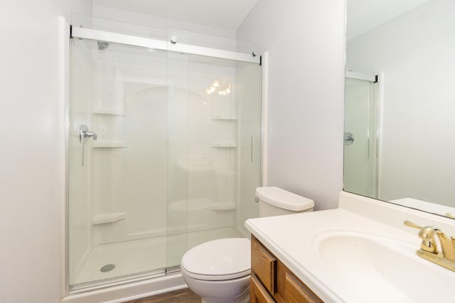 full bath featuring a shower stall, toilet, and vanity