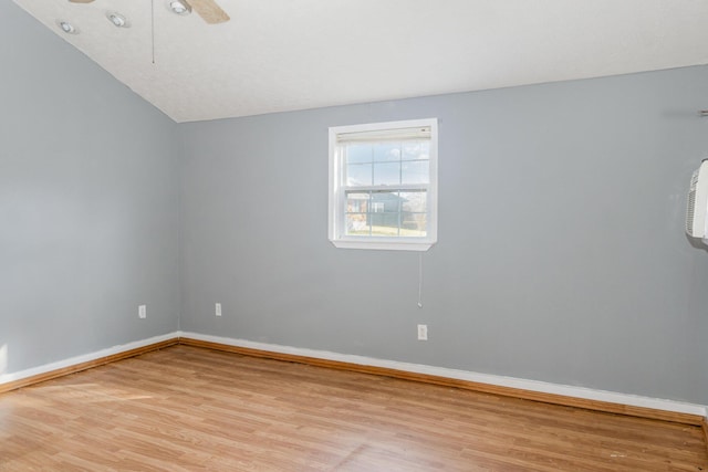 spare room featuring light wood-type flooring, baseboards, and a ceiling fan