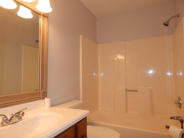 bathroom with shower / bathtub combination, vanity, and toilet