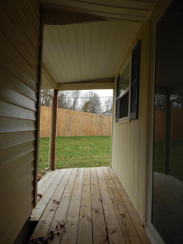 deck with a yard and fence