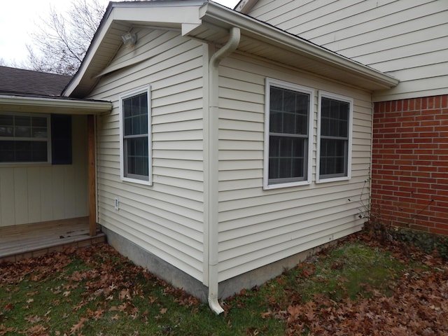 view of side of property featuring brick siding