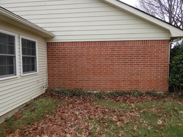 view of property exterior with brick siding