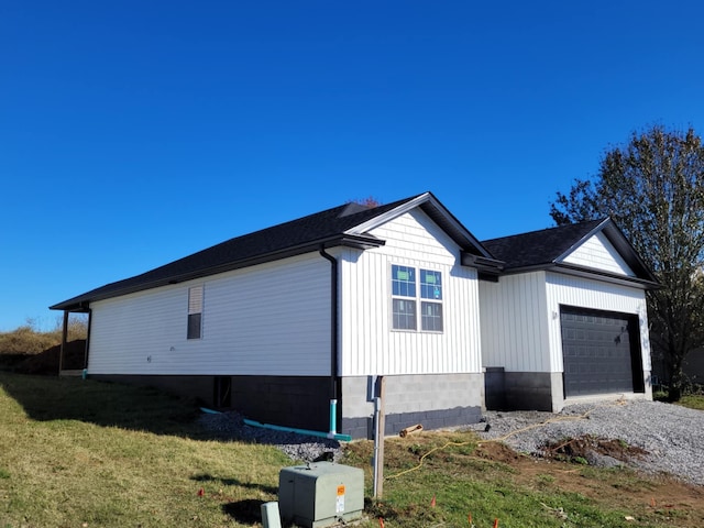 view of home's exterior featuring a garage, driveway, and a lawn