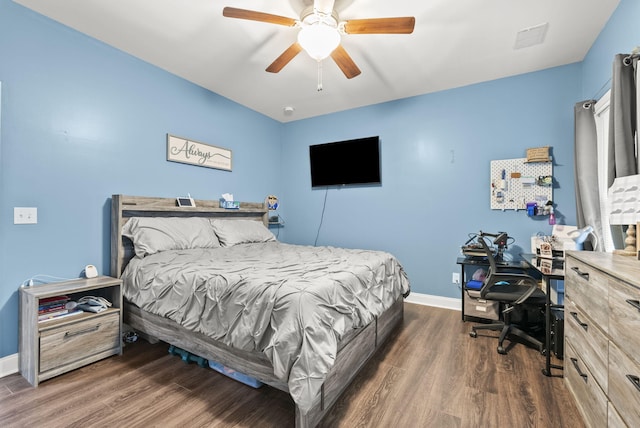 bedroom featuring ceiling fan, wood finished floors, and baseboards