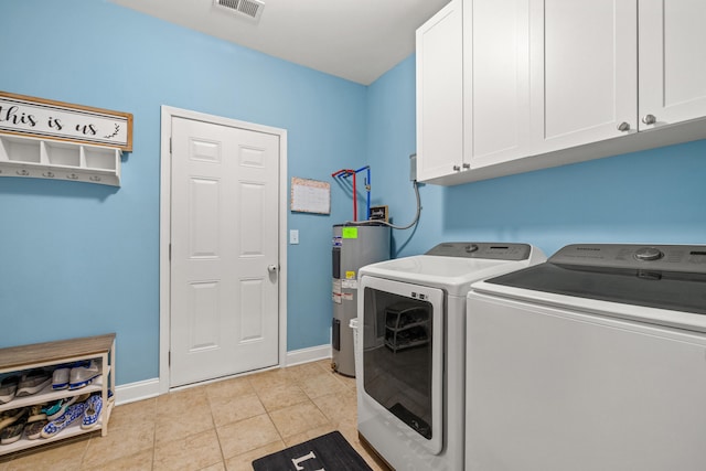 laundry area with cabinet space, light tile patterned floors, visible vents, independent washer and dryer, and water heater