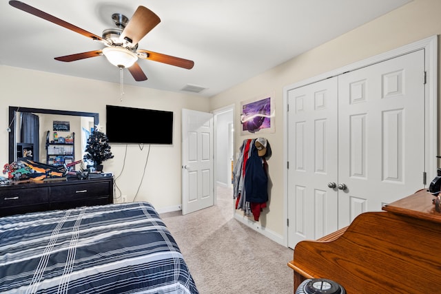 carpeted bedroom featuring ceiling fan, a closet, visible vents, and baseboards