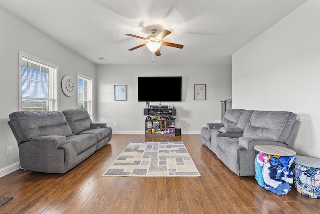 living room featuring baseboards, a ceiling fan, and wood finished floors