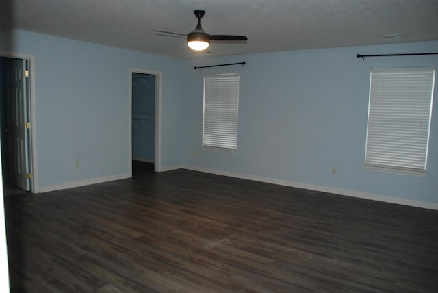 unfurnished room featuring ceiling fan and dark hardwood / wood-style flooring