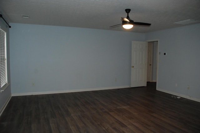 unfurnished room featuring ceiling fan, dark hardwood / wood-style flooring, and a textured ceiling