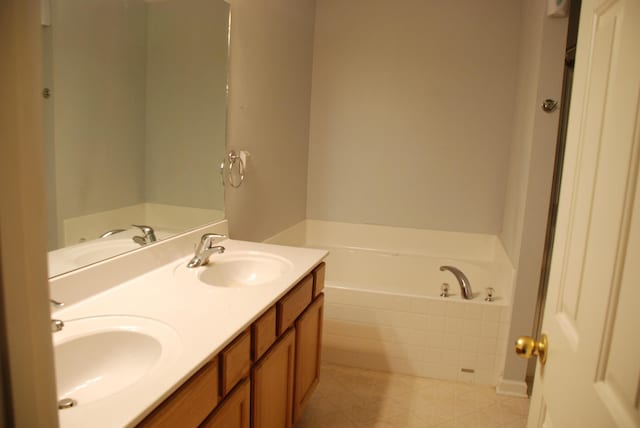 bathroom with a washtub and vanity