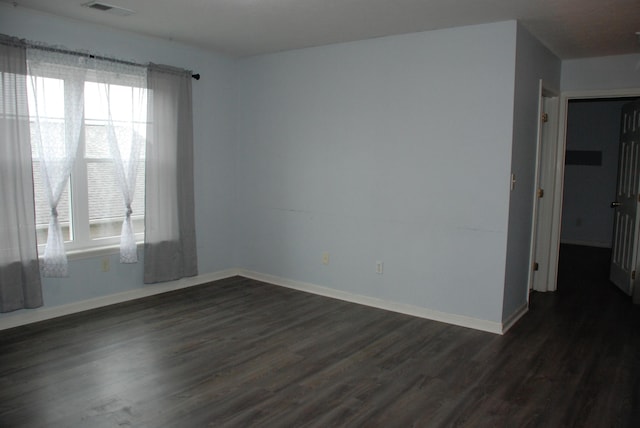 empty room featuring dark wood-type flooring