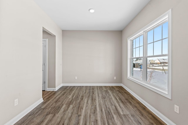 empty room featuring dark wood-type flooring