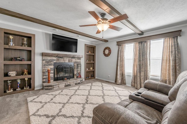 living room featuring beam ceiling, a stone fireplace, built in features, a textured ceiling, and light carpet