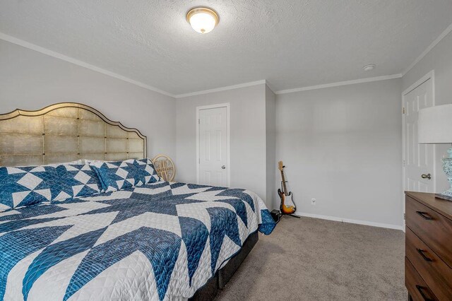 bedroom featuring a textured ceiling, carpet floors, and ornamental molding