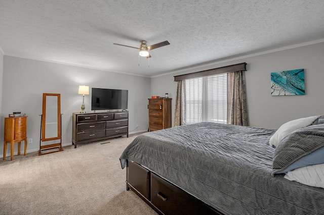 bedroom featuring a textured ceiling, ceiling fan, ornamental molding, and light carpet