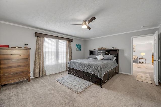 carpeted bedroom featuring a textured ceiling, ceiling fan, and crown molding