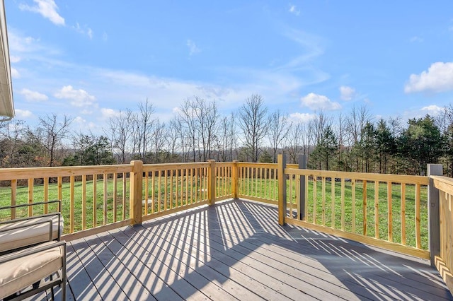 wooden deck featuring a lawn