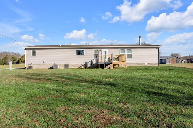 back of property with a lawn, a wooden deck, and central air condition unit