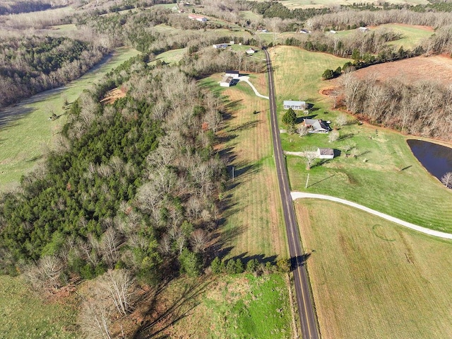 birds eye view of property featuring a rural view and a water view