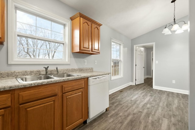 kitchen featuring dishwasher, sink, hanging light fixtures, dark hardwood / wood-style flooring, and a chandelier