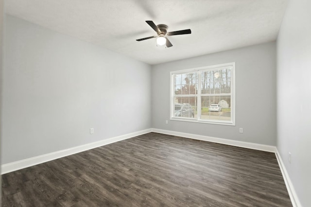 empty room with ceiling fan and dark hardwood / wood-style floors