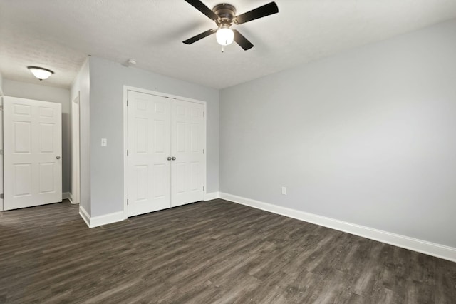 unfurnished bedroom featuring a closet, ceiling fan, and dark wood-type flooring