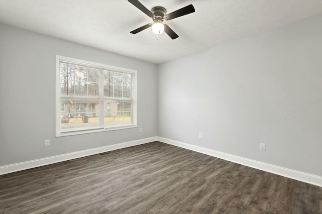 unfurnished room with ceiling fan and dark wood-type flooring