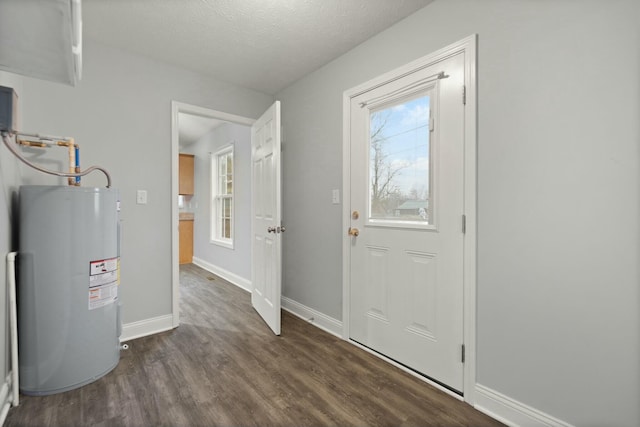 entrance foyer with a textured ceiling, electric water heater, and dark wood-type flooring